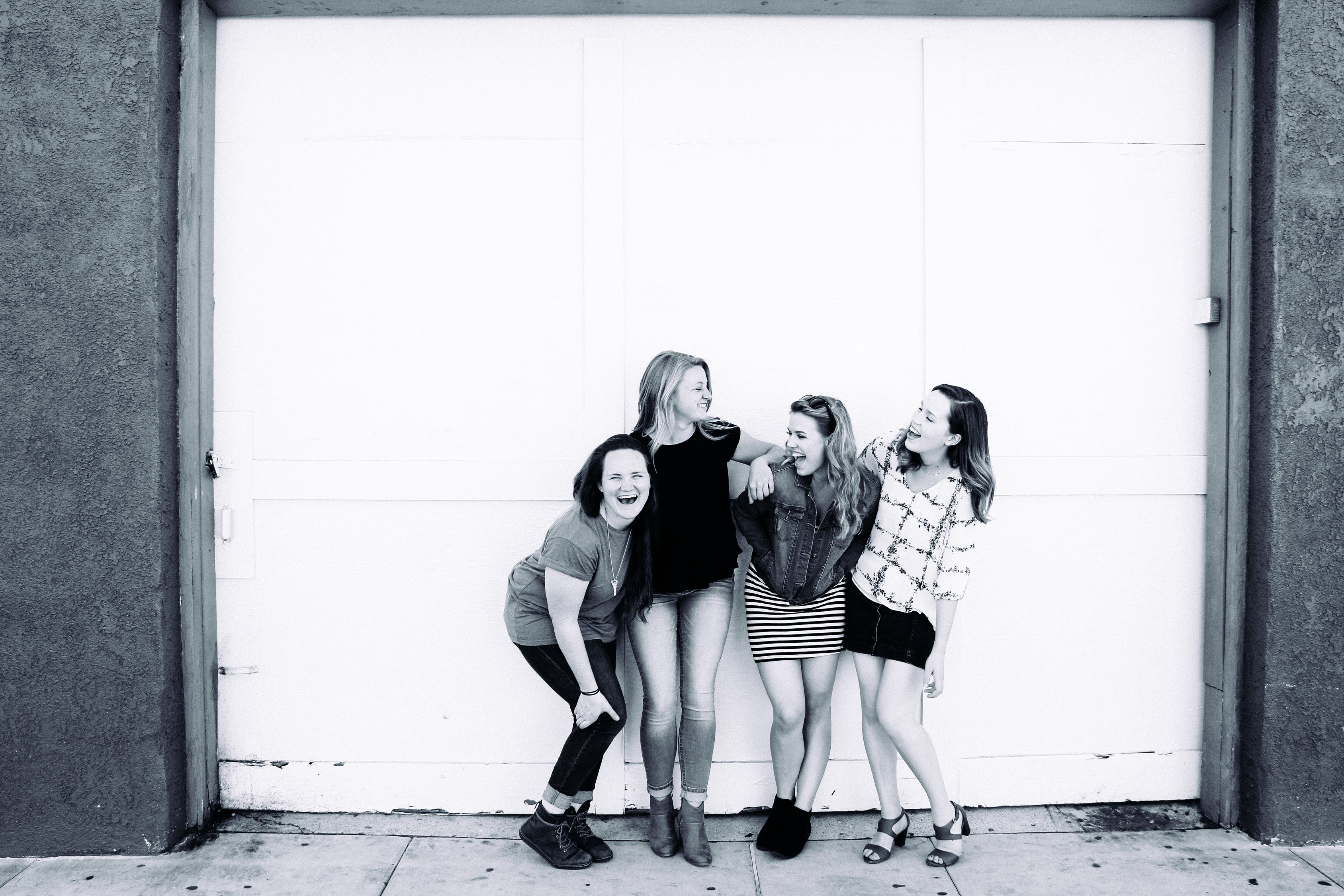 B and W four young women laughing