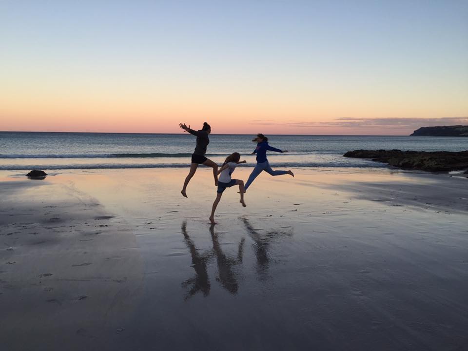Girls leaping on sunset beach, BH